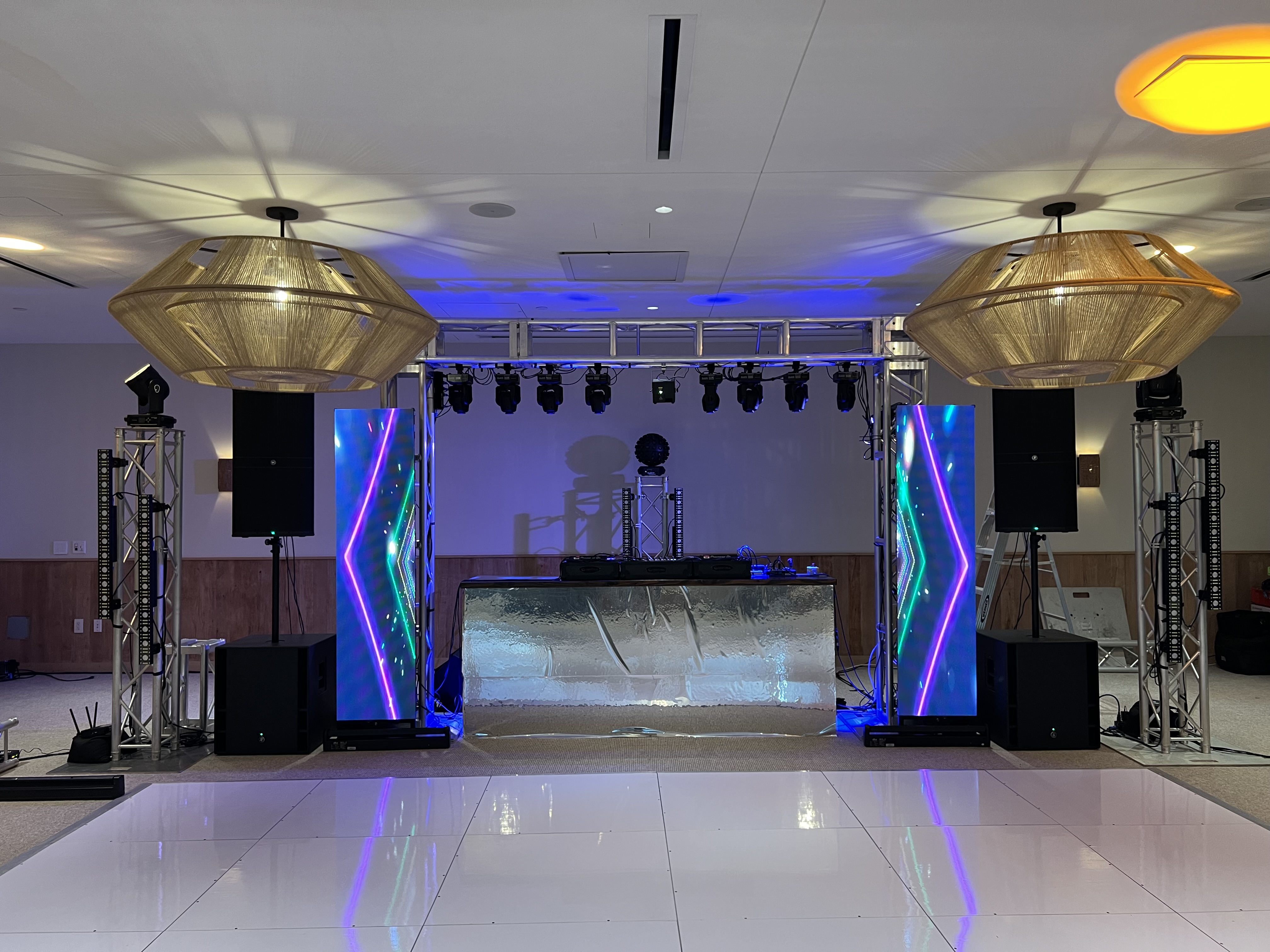 Full AV production — truss, moving heads, LED panels, ice bar DJ setup